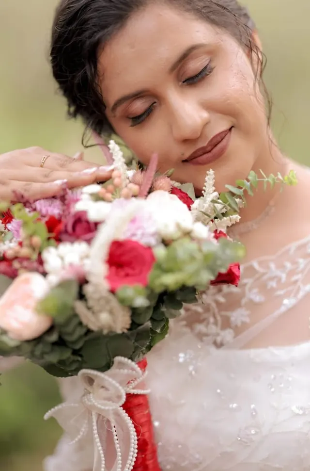 Bride in soft, natural dewy makeup holding her bouquet