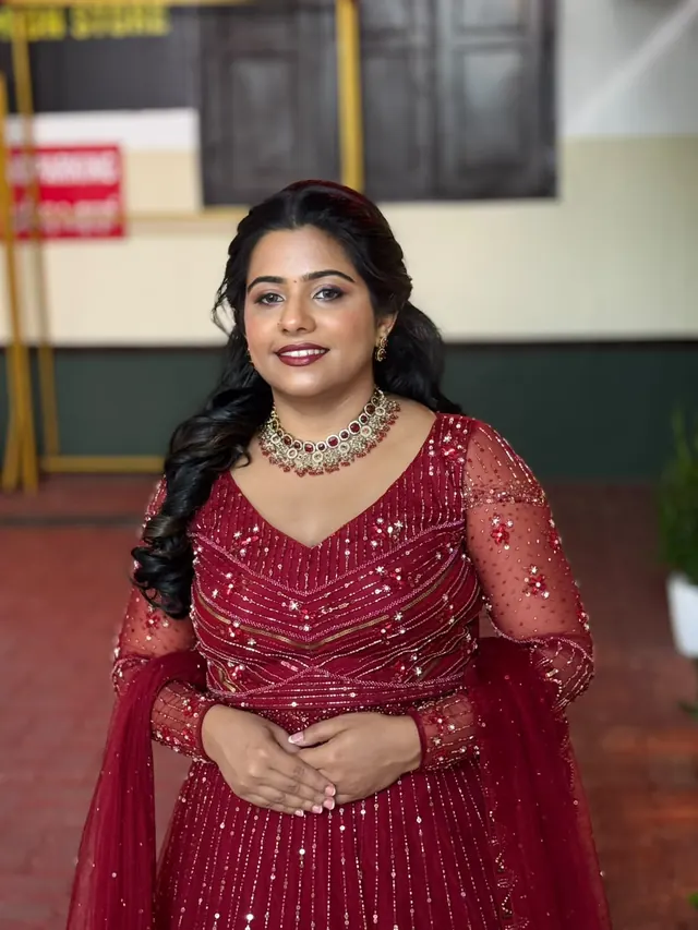 Bride in a sequinned maroon gown with ruby choker and soft curled hair